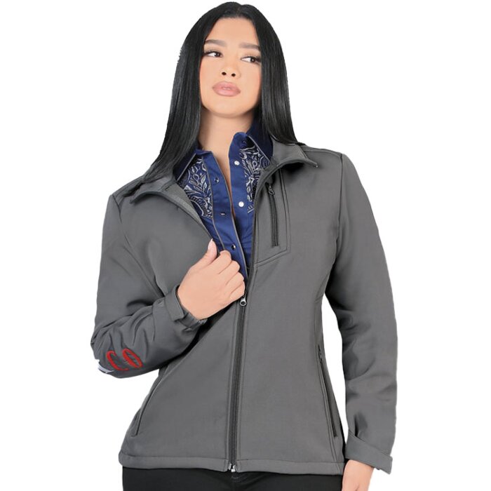 A woman wearing a gray softshell jacket with Mexico embroidery on the sleeve.