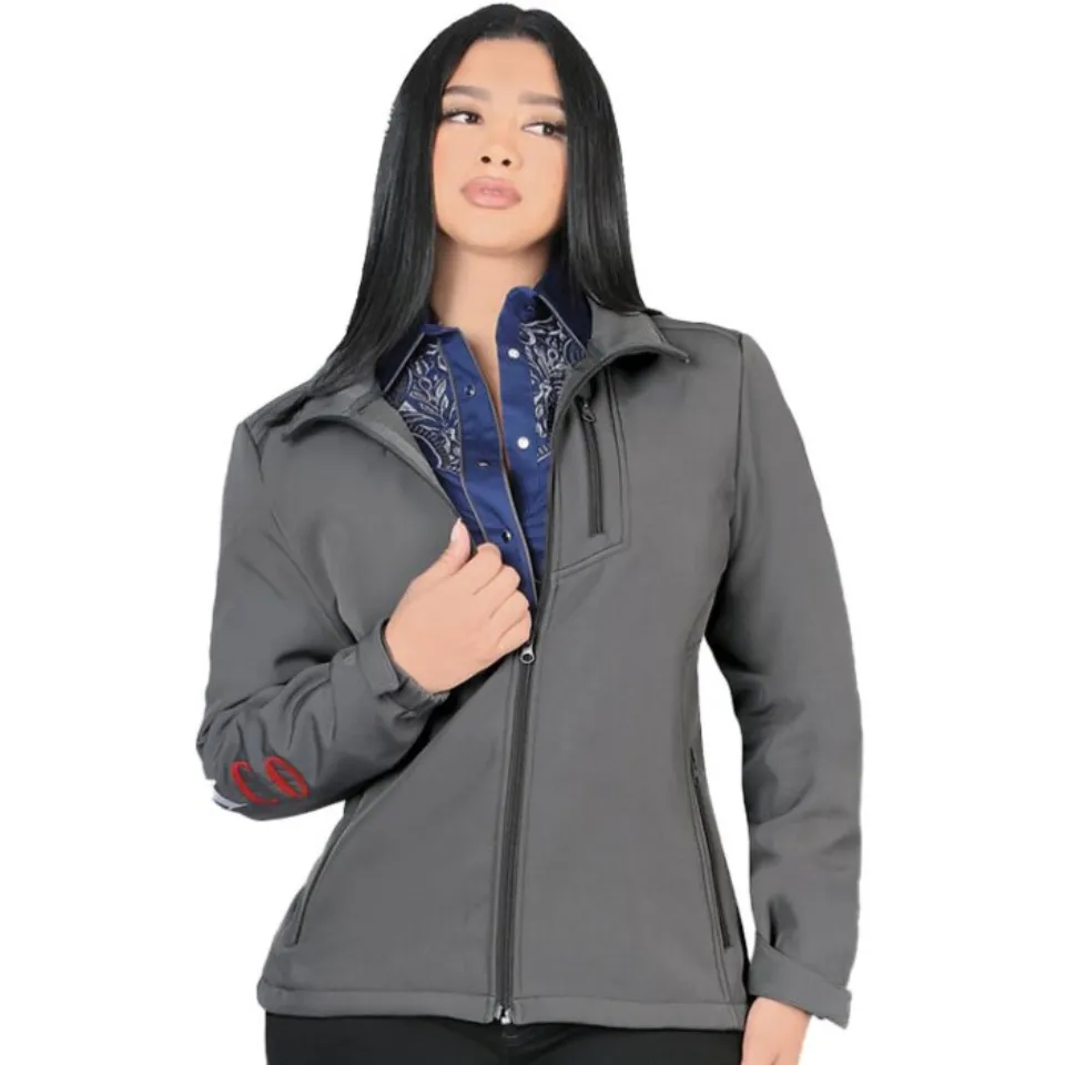 A woman wearing a gray softshell jacket with Mexico embroidery on the sleeve.