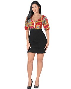 Full-body view of a model in a red, gold, and black print dress.