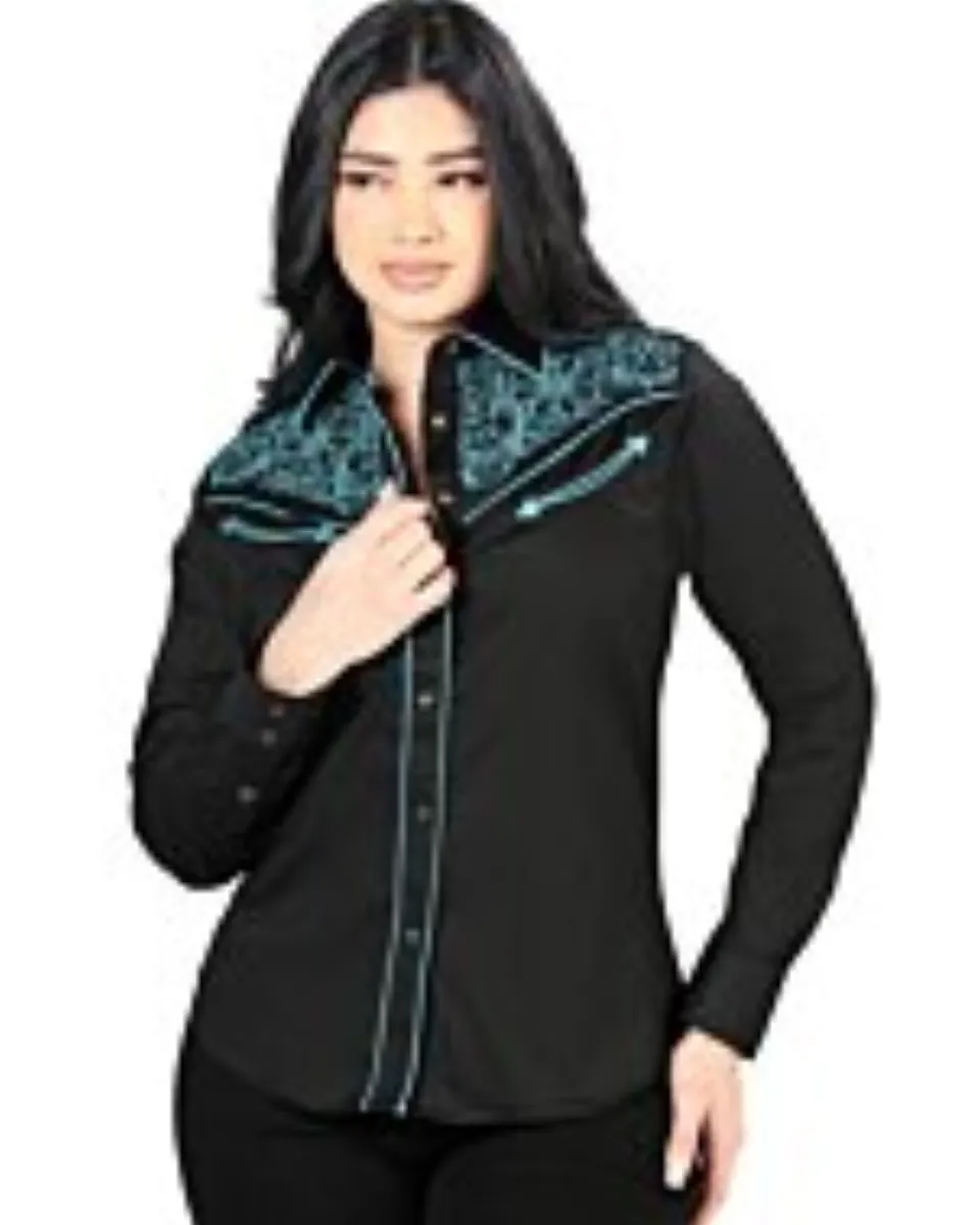 Mujer de pelo negro luciendo blusa vaquera color negro con bordado teal en el frente, botonadura de broche.