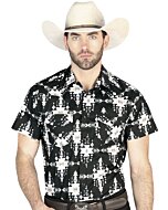 Man wearing a black short-sleeve Western shirt featuring intricate tribal-inspired geometric patterns in black and white with snap-button closure.